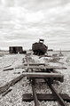 Old tracks leading to a boat and shack across a shingle spit