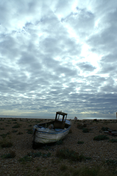 An old fishing boat under a brooding sky