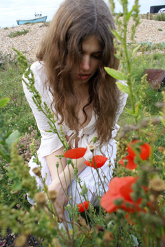 Girl in white lace among poppies