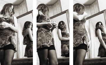 triptych of female in sheer slip and stockings applying lipstick in large mirror