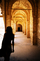 girl silhouetted in Tunisian arches
