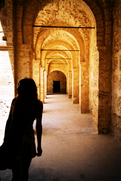girl silhouetted in Tunisian arches