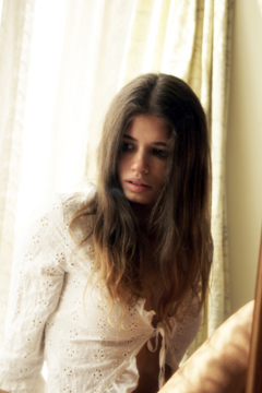 Female in white lace illuminated by the morning sun