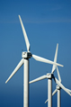 Three wind turbines against a clear blue summer sky