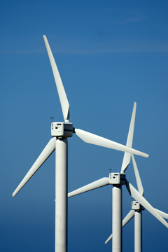 Three wind turbines against a clear blue summer sky